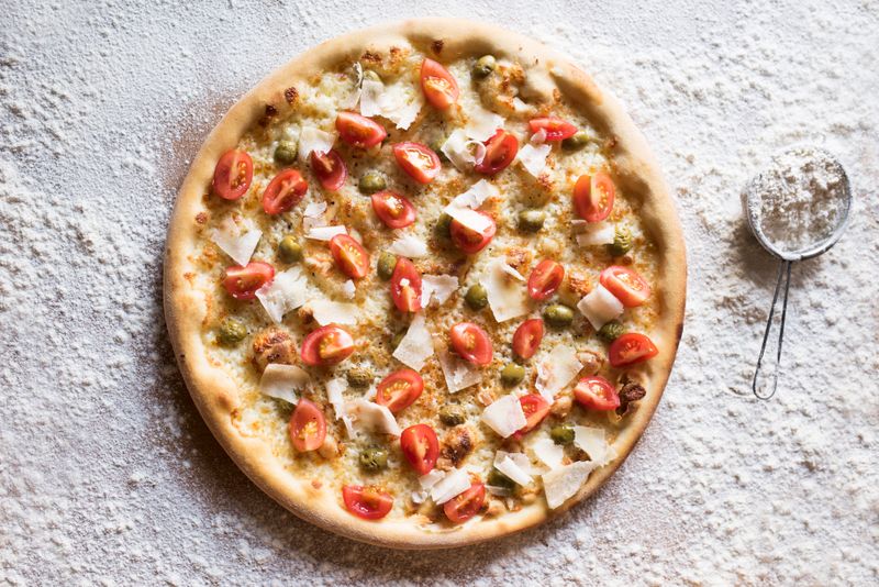 White truffle pizza with ricotta and arugula